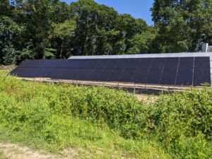 Ground-mounted solar array in a field.