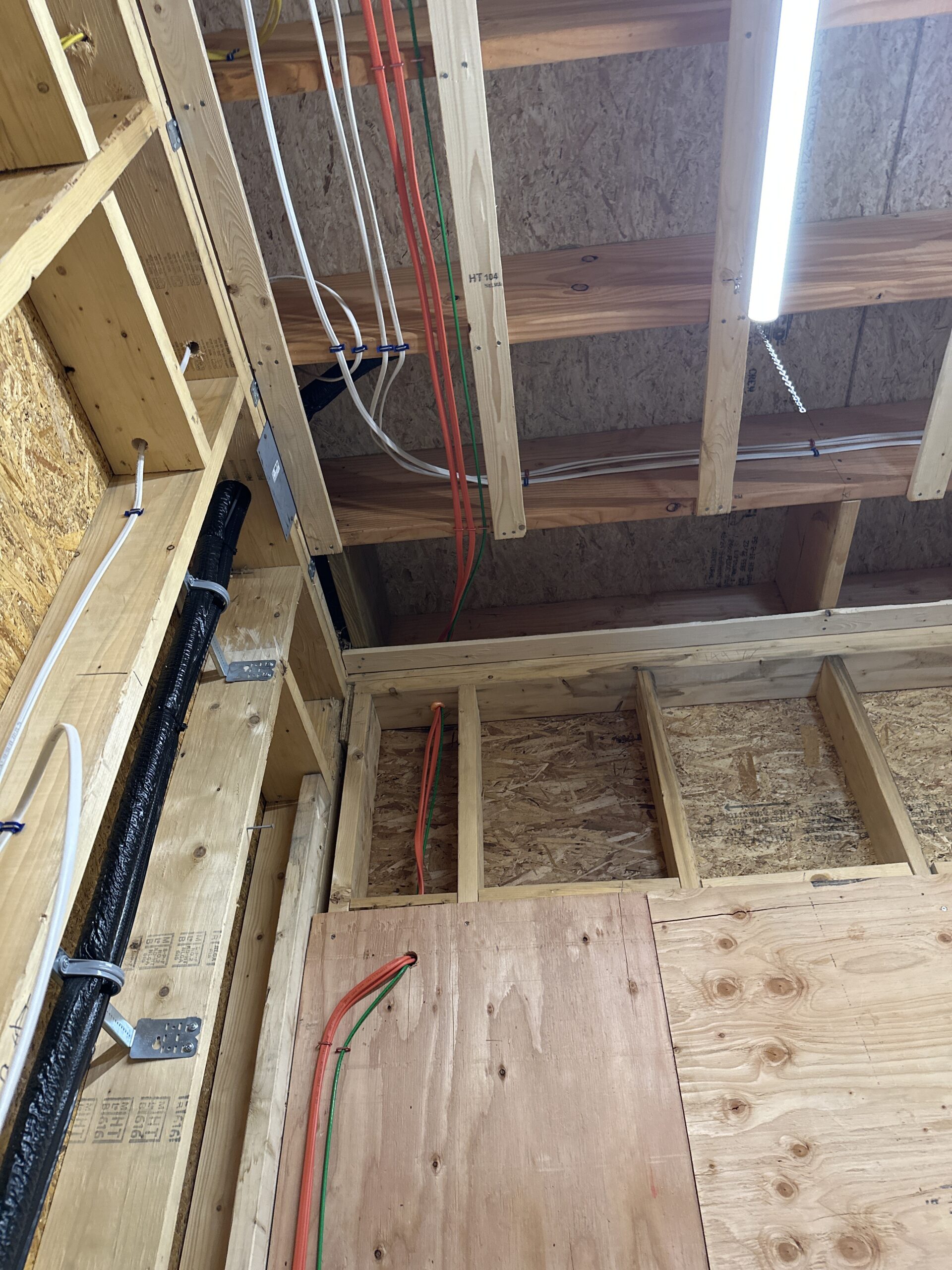 An image of the interior of a home under construction with exposed wiring.